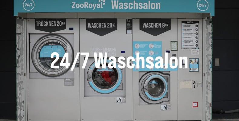 Waschsalon Selbstbedienungs‑Waschsalon mit mehreren Wasch‑ und Trockenmaschinen sowie großem Hinweis „24/7 Waschsalon“.
