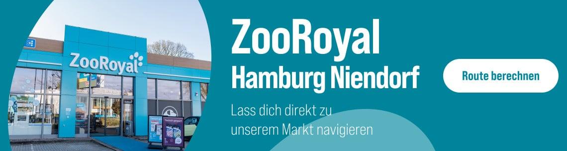 Route zum ZooRoyal Fachmarkt Hamburg Niendorf berechnen Außenansicht des ZooRoyal‑Markts in Hamburg‑Niendorf mit blauem Eingangsbereich und Hinweis zur Routenberechnung.