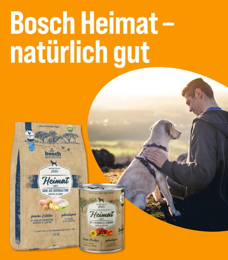 Entdecke Bosch Heimat Aktionsbanner mit Bosch Heimat Hundefutterprodukten und einem Hund in einer Natur‑Szene.
