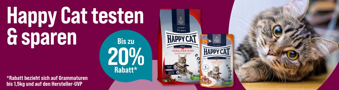 Spare bis zu 20 % auf Happy Cat Aktionsbanner für Happy Cat Katzenfutter. Links der Schriftzug „Happy Cat testen & sparen“ auf magentafarbenem Hintergrund. Mittig zwei Happy Cat Produkte, bestehend aus Trockenfutter und Nassfutter, sowie ein türkisfarbener Kreis mit dem Hinweis „Bis zu 20 % Rabatt“. Rechts eine getigerte Katze in Nahaufnahme. Unten links Hinweistext: „Rabatt bezieht sich auf Grammaturen bis 1,5 kg und auf den Hersteller-UVP“. Hinweis: Werbemotiv in Magenta, Türkis und Weiß mit Fokus auf Happy Cat Katzenfutter und Rabattaktion.