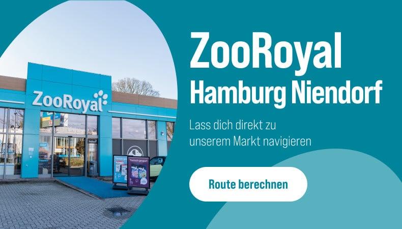 Route zum ZooRoyal Fachmarkt Hamburg Niendorf berechnen Außenansicht des ZooRoyal‑Markts in Hamburg‑Niendorf mit blauem Eingangsbereich und Hinweis zur Routenberechnung.